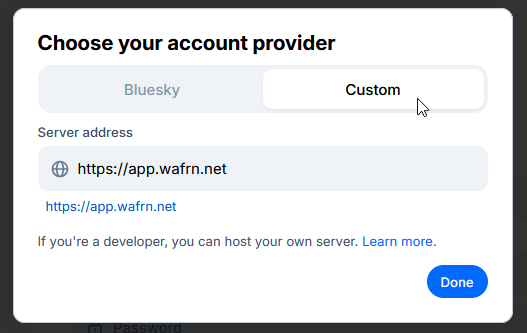 The Bluesky login page after clicking the "hosting provider" field. The cursor has selected the "Custom" option and has filled in the server address as "https://app.wafrn.net".